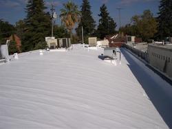 Fluid applied reinforced roof system after